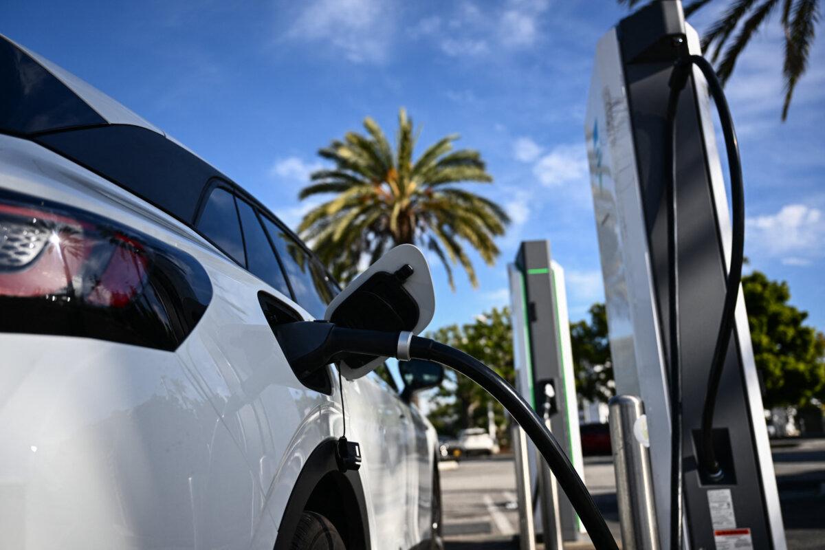 An electric vehicle charges at a shopping mall parking lot in Torrance, Calif., on Feb. 23, 2024. State regulators are looking at ways to continue encouraging electric vehicle sales despite federal rollbacks. (Patrick T. Fallon/AFP via Getty Images)