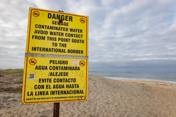 Water advisory signs line the sand of Imperial Beach, Calif., on Sept. 19, 2024. (John Fredricks/The Epoch Times)