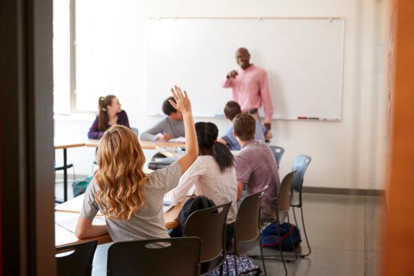 View Through Doorway Of High School Tutor At Whiteboard Teaching Class