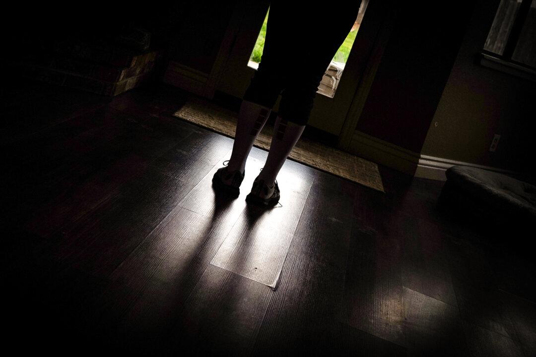 A girl who socially transitioned to a male identity at school without her family's knowledge stands in Chico, Calif., on March 12, 2023. (John Fredricks/The Epoch Times)