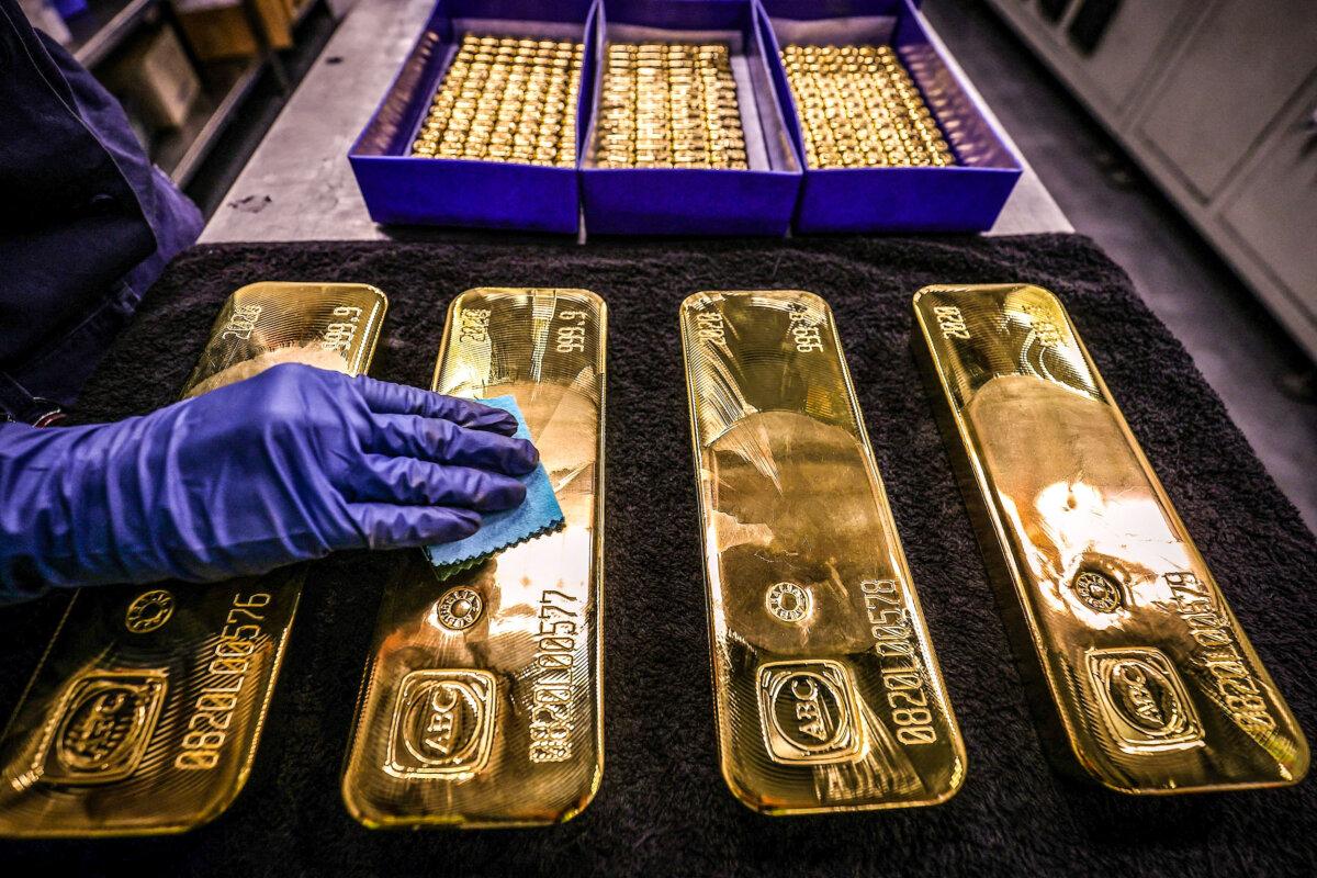 A worker polishes gold bullion bars at the ABC Refinery in Sydney on Aug. 5, 2020. (David Gray/AFP via Getty Images)