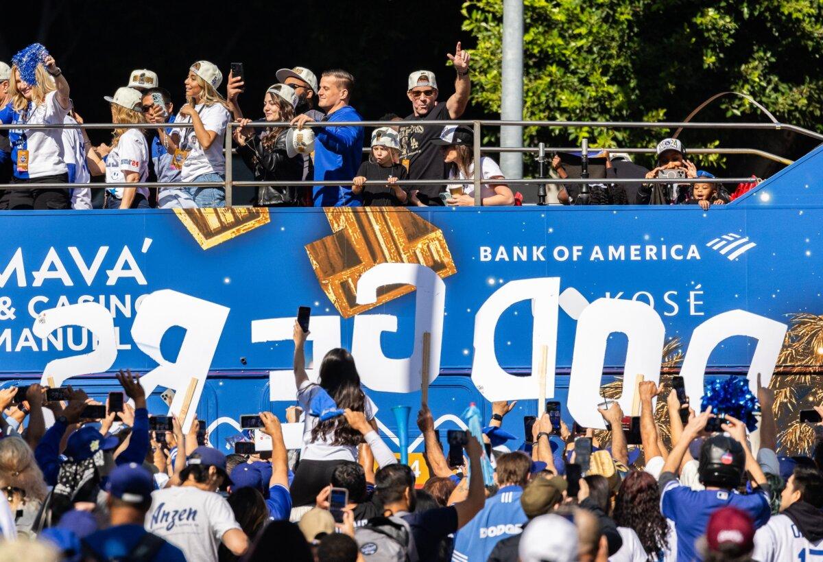 Team members ride in double-decker buses as tens of thousands of Dodger fans flood the streets to celebrate the Dodgers 2024 World Series win in downtown Los Angeles on Nov. 1, 2024. (John Fredricks/The Epoch Times)
