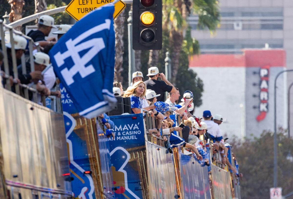 Los Angeles Dodgers teammates and family members greet fans from the top of a bus in Los Angeles on Nov. 1, 2024. (John Fredricks/The Epoch Times)