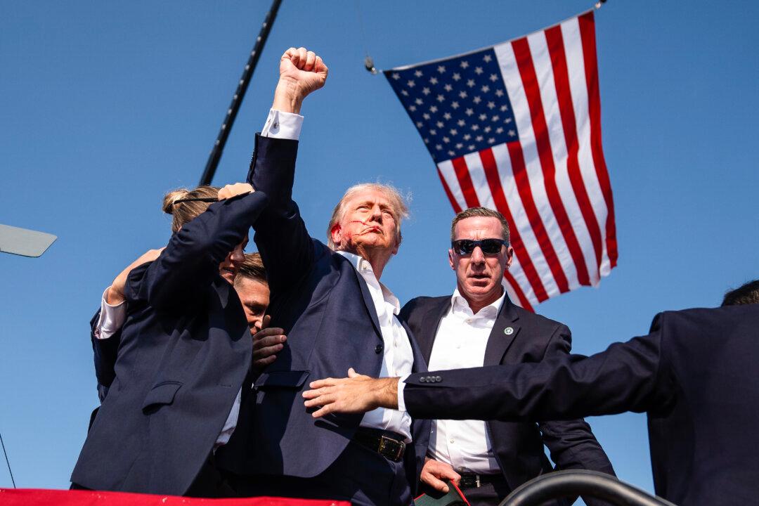 Republican presidential candidate former President Donald Trump raises his fist shortly after the assassination attempt at a campaign rally, in Butler, Pa., on July 13, 2024. (AP Photo/Evan Vucci)