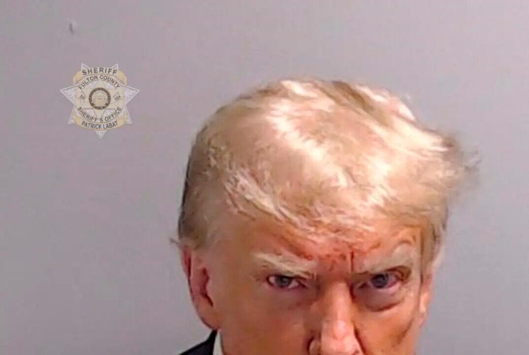 Former President Donald Trump poses for his booking photo at the Fulton County Jail in Atlanta, Ga., on August 24, 2023. Trump was booked on 13 charges related to an alleged plan to overturn the results of the 2020 presidential election in Georgia. (Fulton County Sheriff's Office via Getty Images)