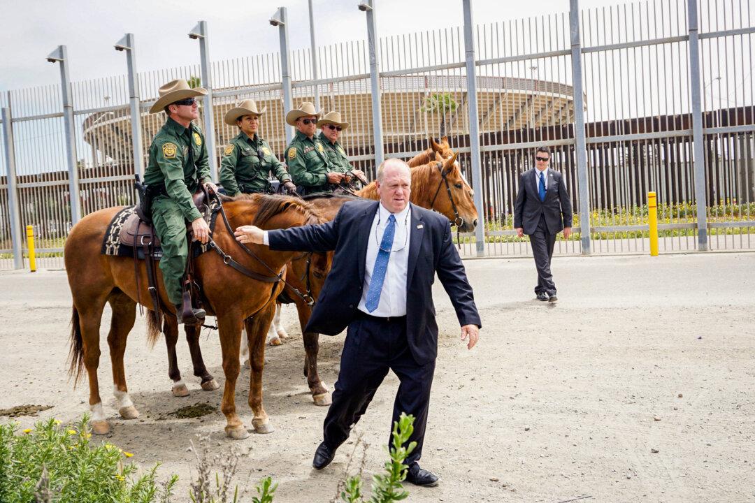Tom Homan shakes hands with Border Patrol agents after a press conference at Border Field State Park in San Ysidro, Calif., on May 7, 2018. (Sandy Huffaker/Getty Images)