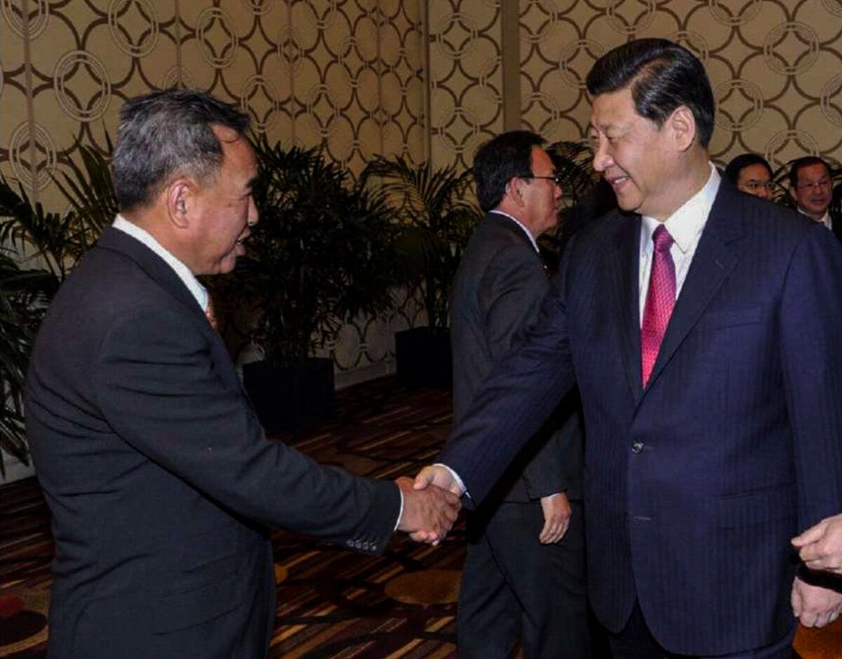 John Chen (L) meets with Chinese communist leader Xi Jinping in Beijing, in an undated photo. (Department of Justice)