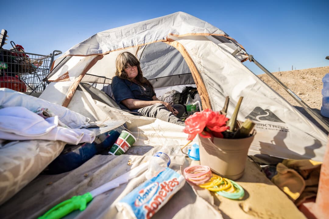 “Kimberly” rests in her tent among dozens of homeless people in Las Vegas on Nov. 14, 2024. (John Fredricks/The Epoch Times)