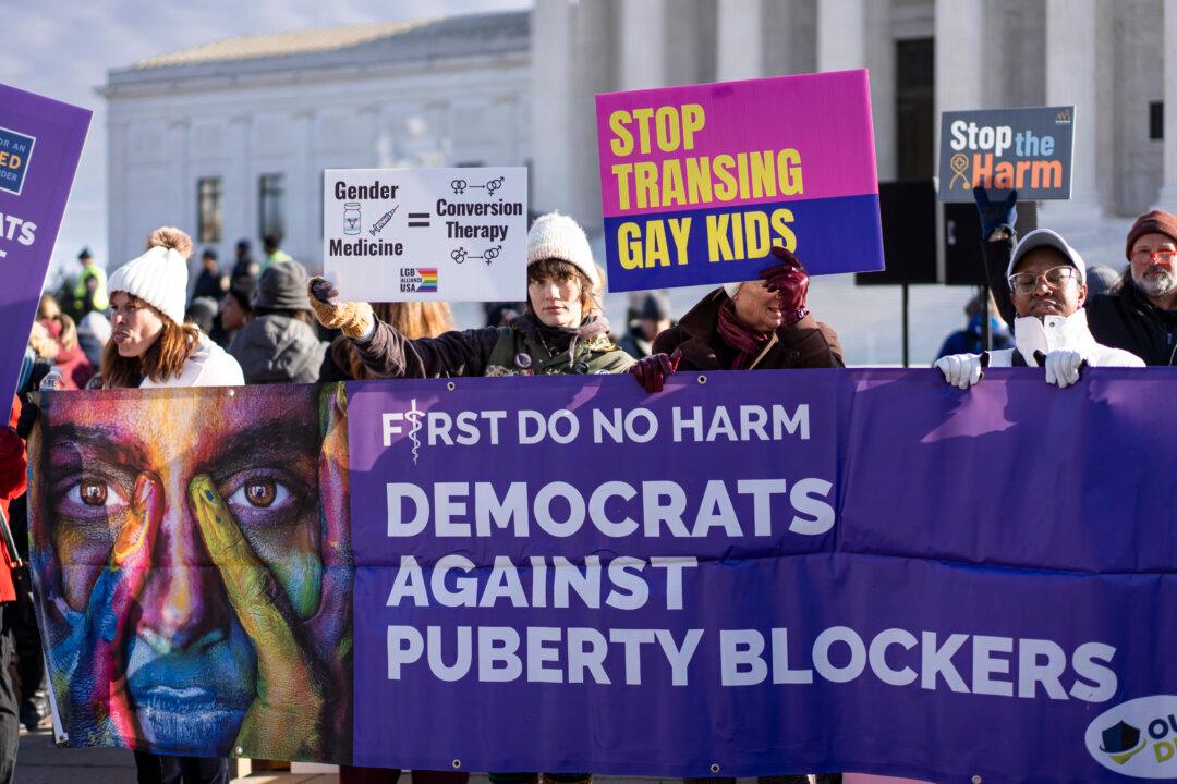 People protest as the Supreme Court hears a case related to the ban of gender-related procedures for minors, in Washington on Dec. 4, 2024. (Madalina Vasiliu/The Epoch Times)