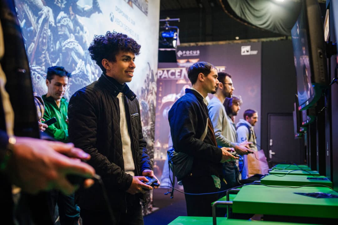 Visitors play the Space Marine video game during a preview of Paris Games Week on Oct. 22, 2024. (Dimitar Dilkoff/AFP via Getty Images)