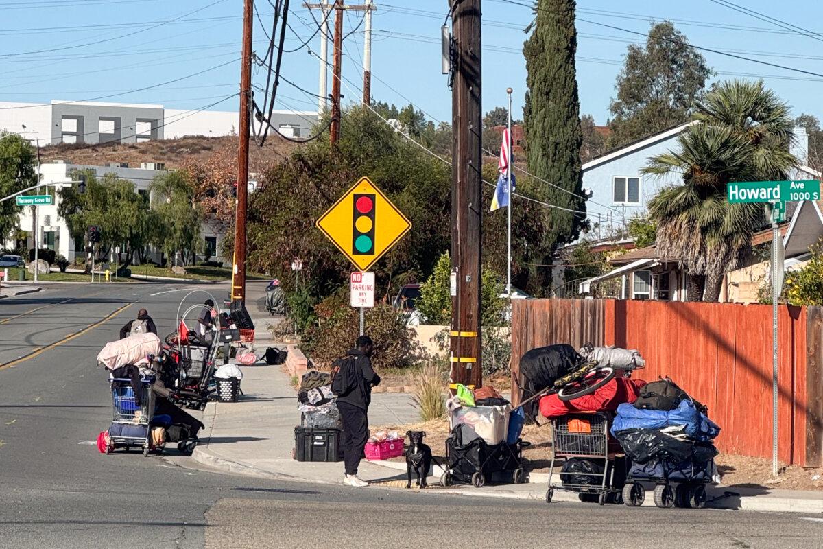 A day after the city cleared a creek bed homeless encampment site, homeless individuals linger along nearby sidewalks in Escondido, Calif., on Dec. 17, 2024. (Courtesy of Kymberly Moon-Walker)