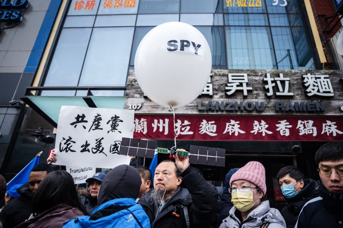 People at a press conference and rally in front of the America ChangLe Association, a now-closed secret Chinese police station, protesting Beijing's transnational repression, in New York City on Feb. 25, 2023. (Samira Bouaou/The Epoch Times)