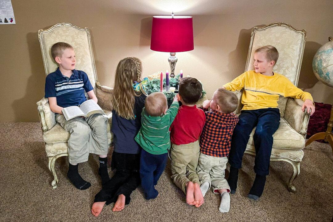 Jessica and Kolby DeWitt's six children gather around an Advent wreath, next to a tiny manger in which they place pieces of straw after doing a kind deed for someone. (Courtesy Jessica DeWitt)