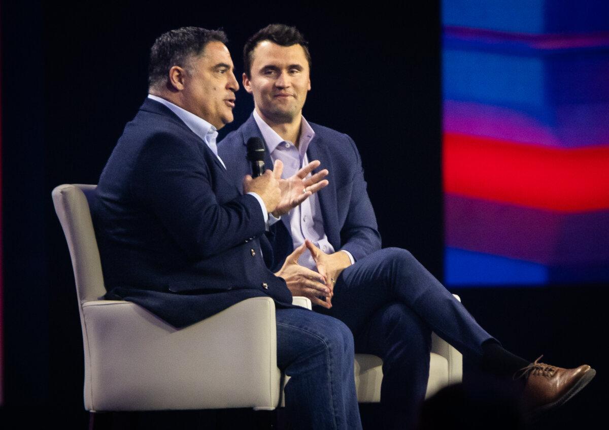 Charlie Kirk and Cenk Uygur speak together on day three of the America (AM) Fest hosted by Turning Point USA in Phoenix, Ariz., on Dec. 21, 2024. (John Fredricks/The Epoch Times)
