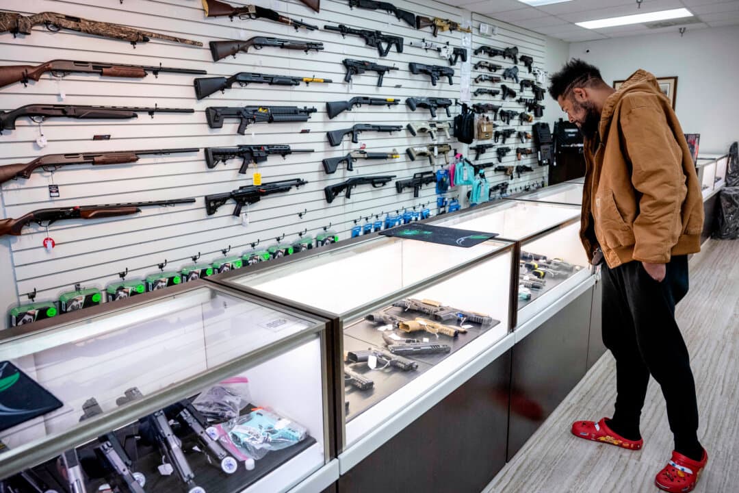 A collector looks at guns in a gun shop in Capitol Heights, Md., on March 14, 2023. (Andrew Caballero-Reynolds/AFP via Getty Images)