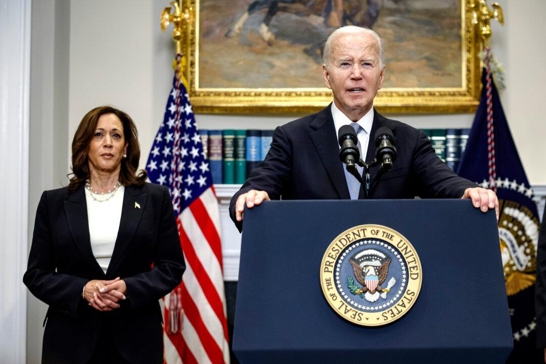 President Joe Biden delivers remarks as Vice President Kamala Harris looks on, at the White House on July 14, 2024. (Kevin Dietsch/Getty Images)