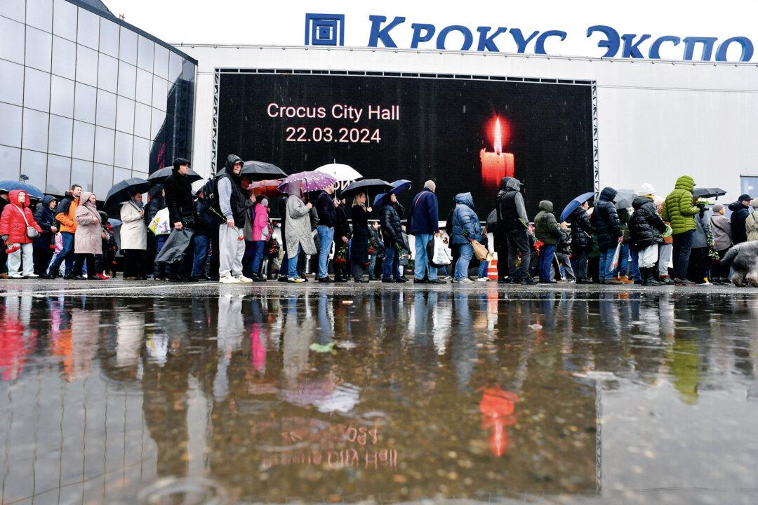 Mourners stand in a queue to lay flowers at a makeshift memorial after a massacre that killed 145 people, in front of the Crocus City Hall in Krasnogorsk, Russia, on March 24, 2024. (Olga Maltseva/AFP via Getty Images)