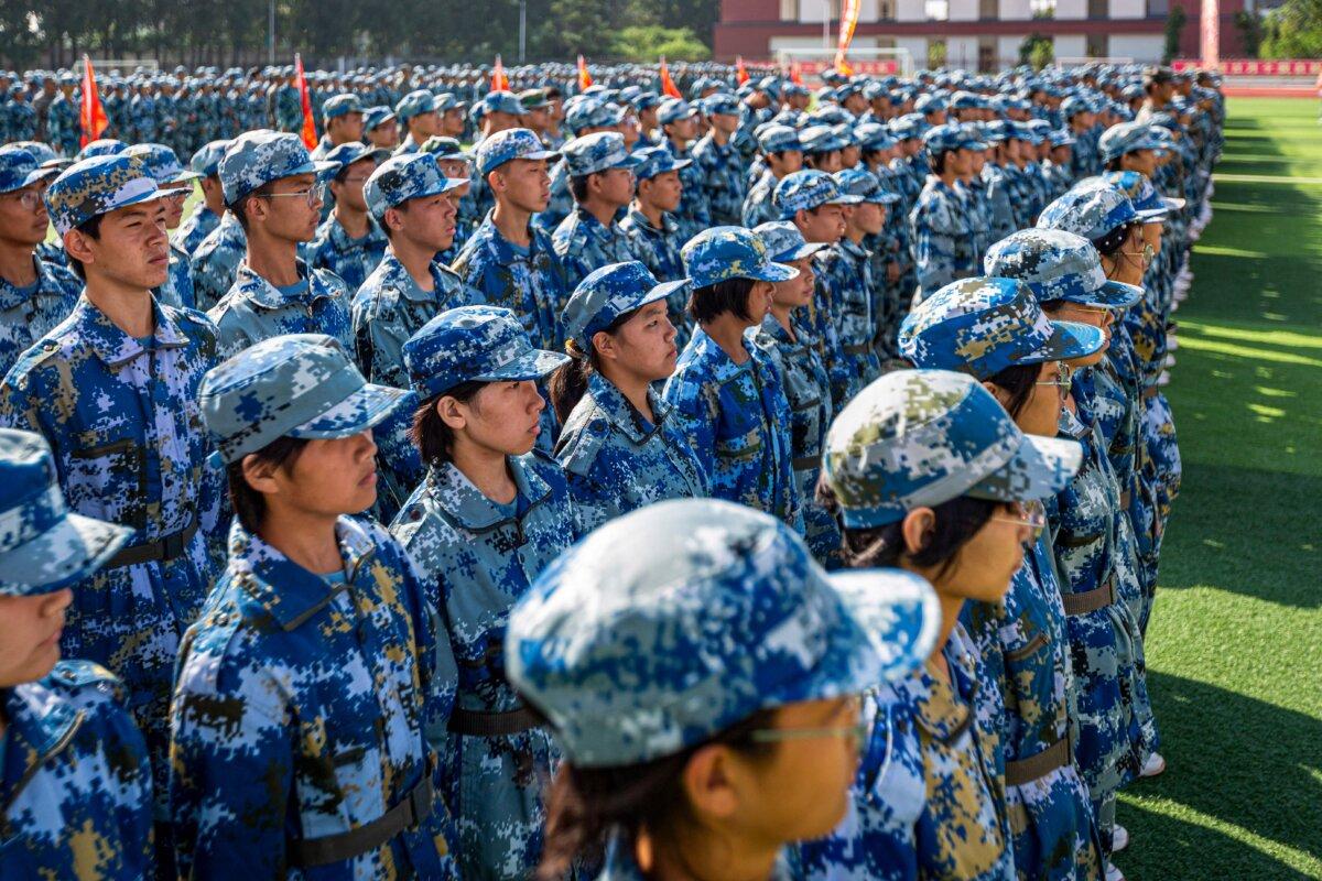 Middle school students participate in a military training ceremony in Anyang, Henan Province, China, on Aug. 28, 2023. (STR/AFP via Getty Images)