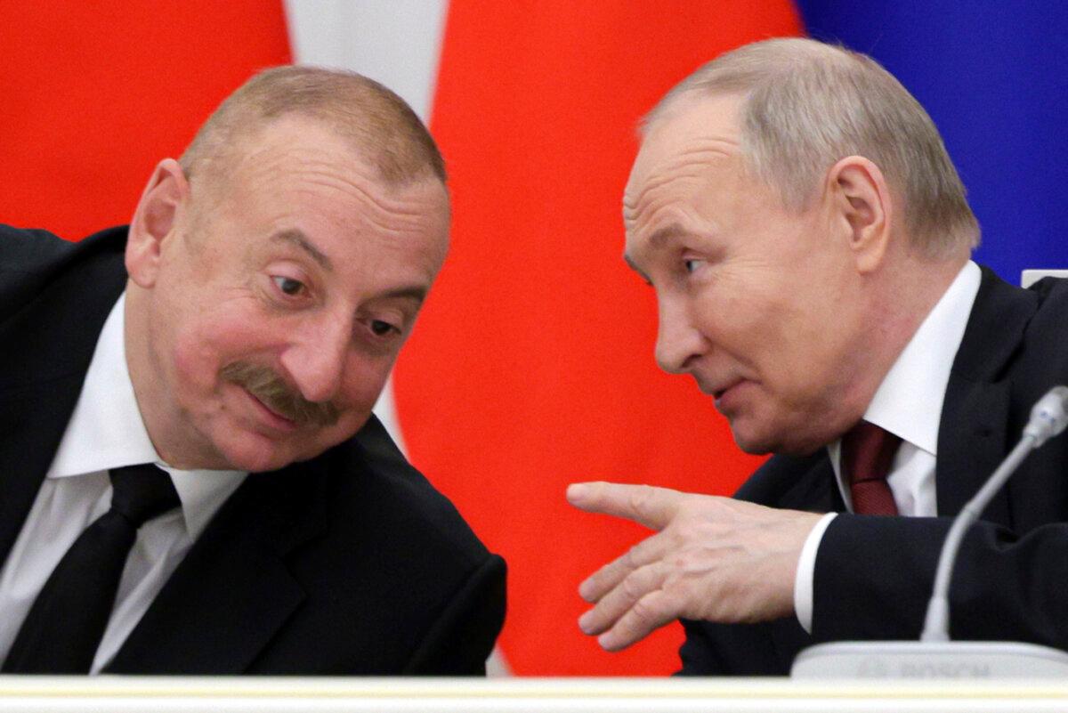 Russian President Vladimir Putin (R) and Azerbaijani President Ilham Aliyev attend a meeting with railway industry veterans at the Kremlin in Moscow on April 22, 2024. (Gavriil Grigorov/Sputnik/Kremlin Pool Photo via AP)