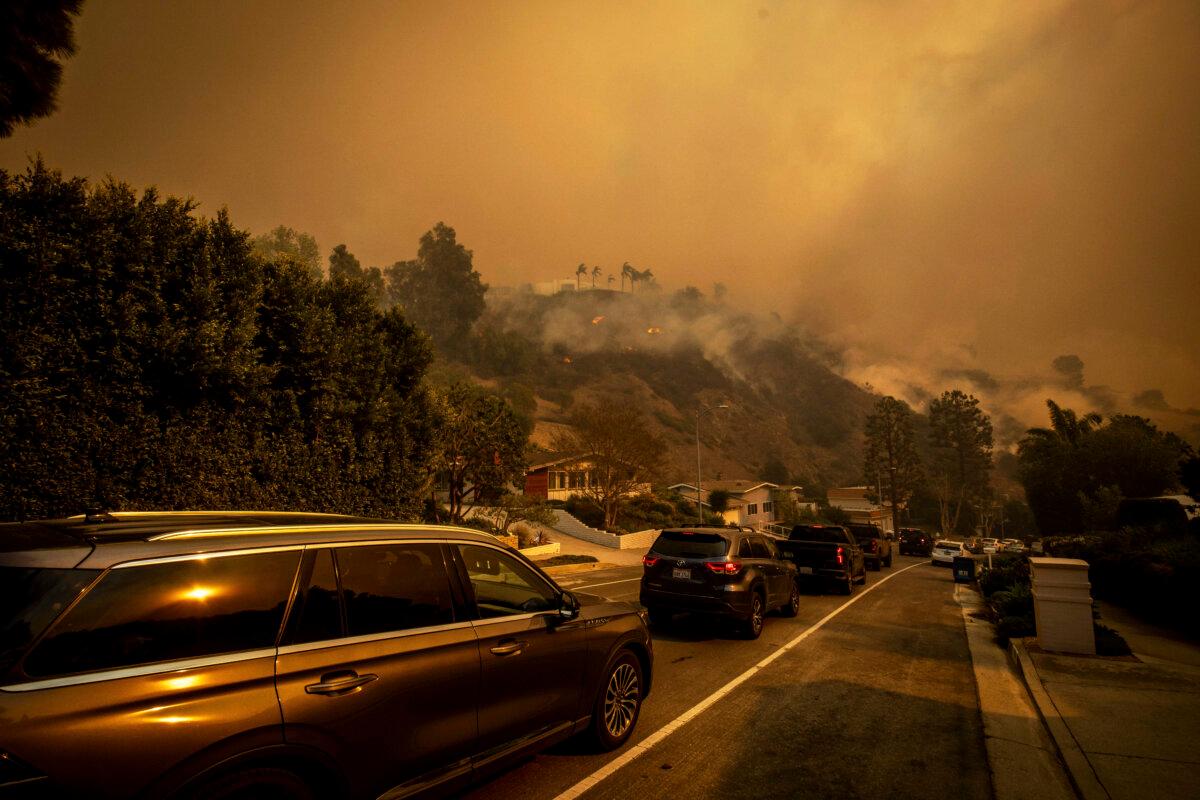 A line of vehicles crowds the road as residents flee from the Palisades Fire in the Pacific Palisades neighborhood of Los Angeles on Jan. 7, 2025. (Ethan Swope/AP Photo)