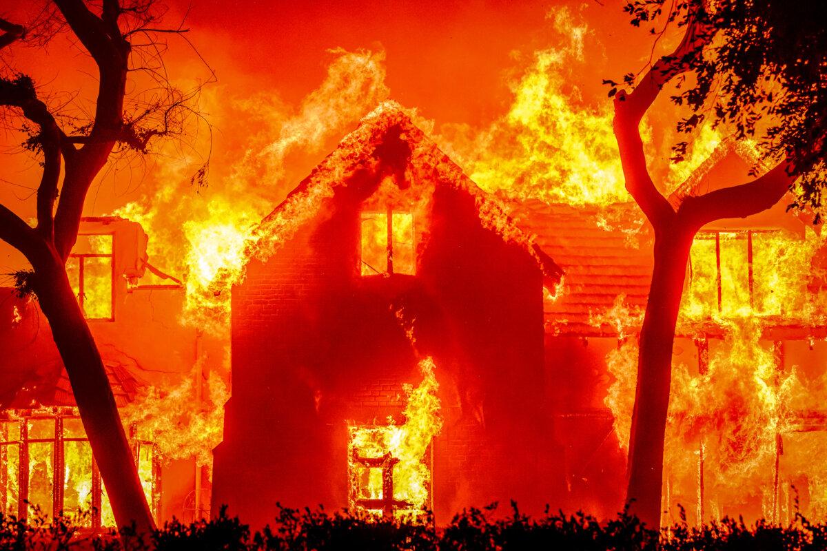 A home is engulfed in flames during the Eaton Fire in the Altadena area of Los Angeles County, Calif., on Jan. 8, 2025. (Josh Edelson/AFP via Getty Images)