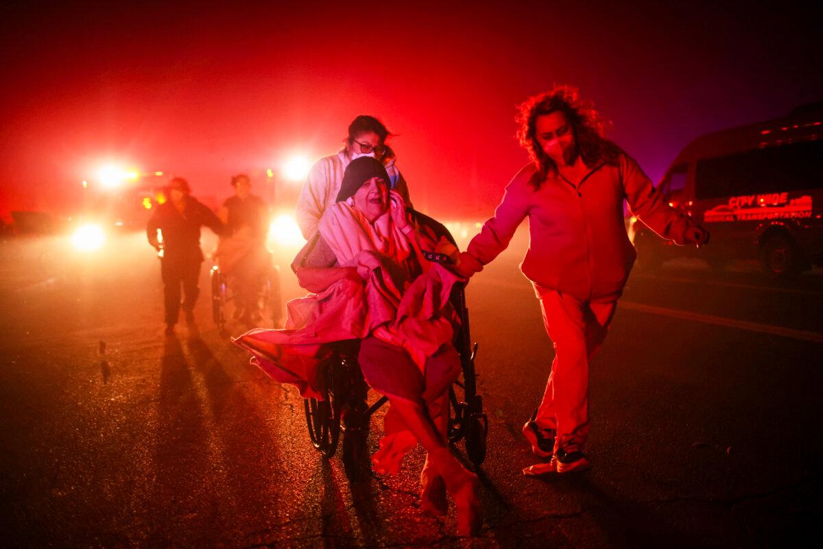 Residents of a senior center are evacuated as the Eaton Fire approaches in Altadena, Calif., on Jan. 7, 2025. (Ethan Swope/AP Photo)