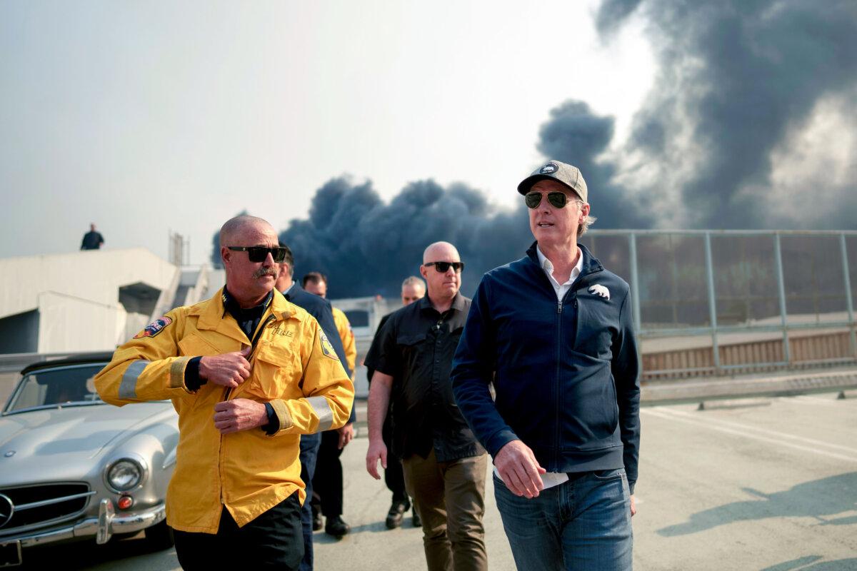 California Gov. Gavin Newsom (R) tours the downtown business district of Pacific Palisades as the Palisades Fire continues to burn in Los Angeles on Jan. 8, 2025. (Eric Thayer/Getty Images)