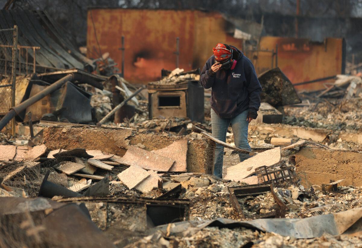 Mimi Laine inspects her mother's house, which was destroyed by the Eaton Fire in Altadena, Calif., on Jan. 9, 2025. (Justin Sullivan/Getty Images)