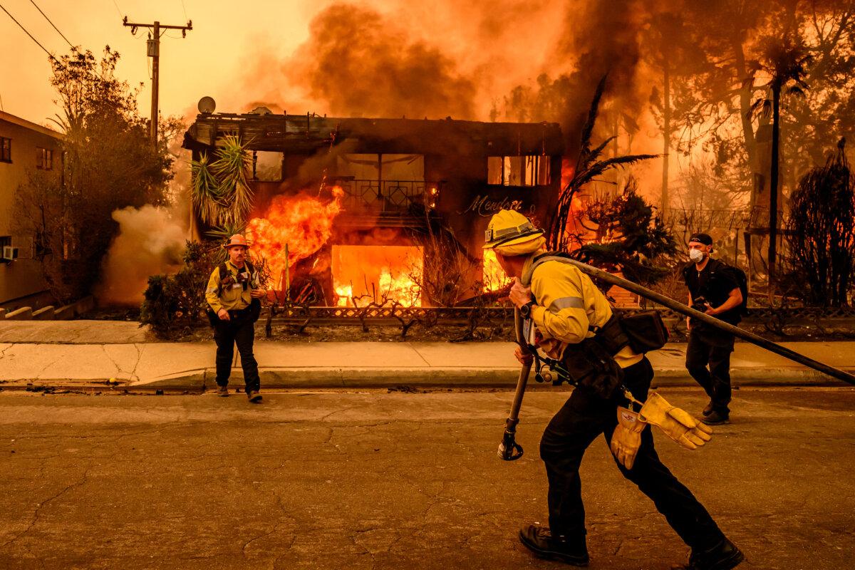 Firefighters work the scene as an apartment building burns during the Eaton Fire in the Altadena area of Los Angeles County on Jan. 8, 2025. (Josh Edelson/AFP via Getty Images)