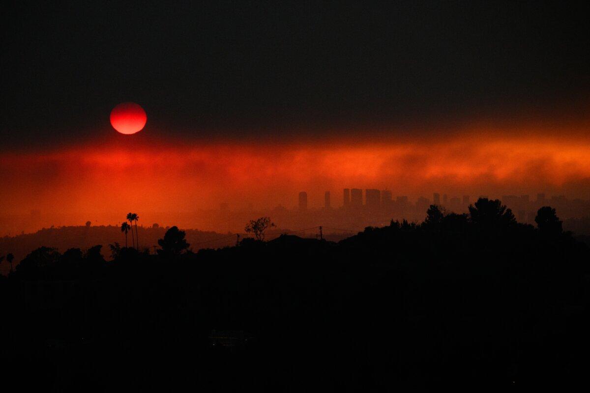 An aerial image shows smoke from wildfires including the Eaton fire and Palisades fire in Los Angeles on Jan. 8, 2025. (Patrick T. Fallon/AFP via Getty Images)