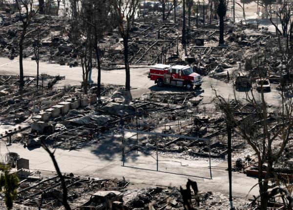 A fire crew drives through a mobile home park destroyed by the Palisades Fire on Jan. 14, 2025. (Justin Sullivan/Getty Images)
