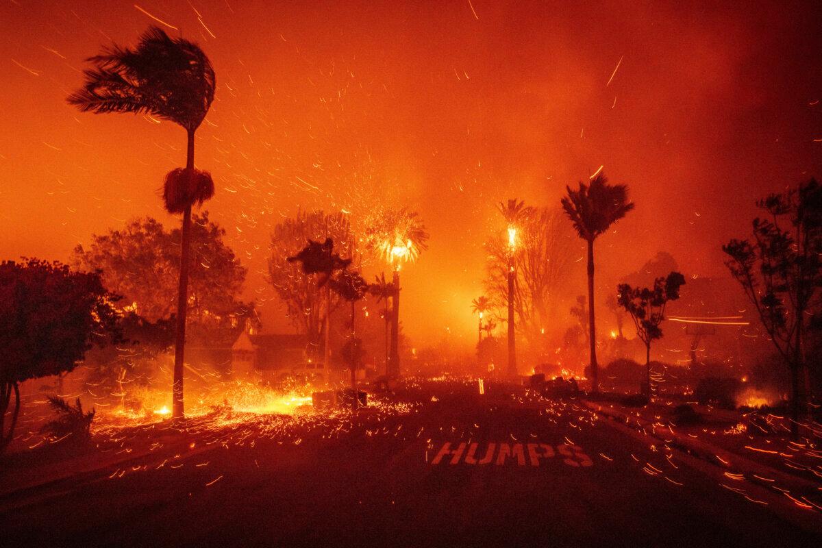 The Palisades Fire ravages a neighborhood amid high winds in the Pacific Palisades neighborhood of Los Angeles on Jan. 7, 2025. (AP Photo/Ethan Swope)