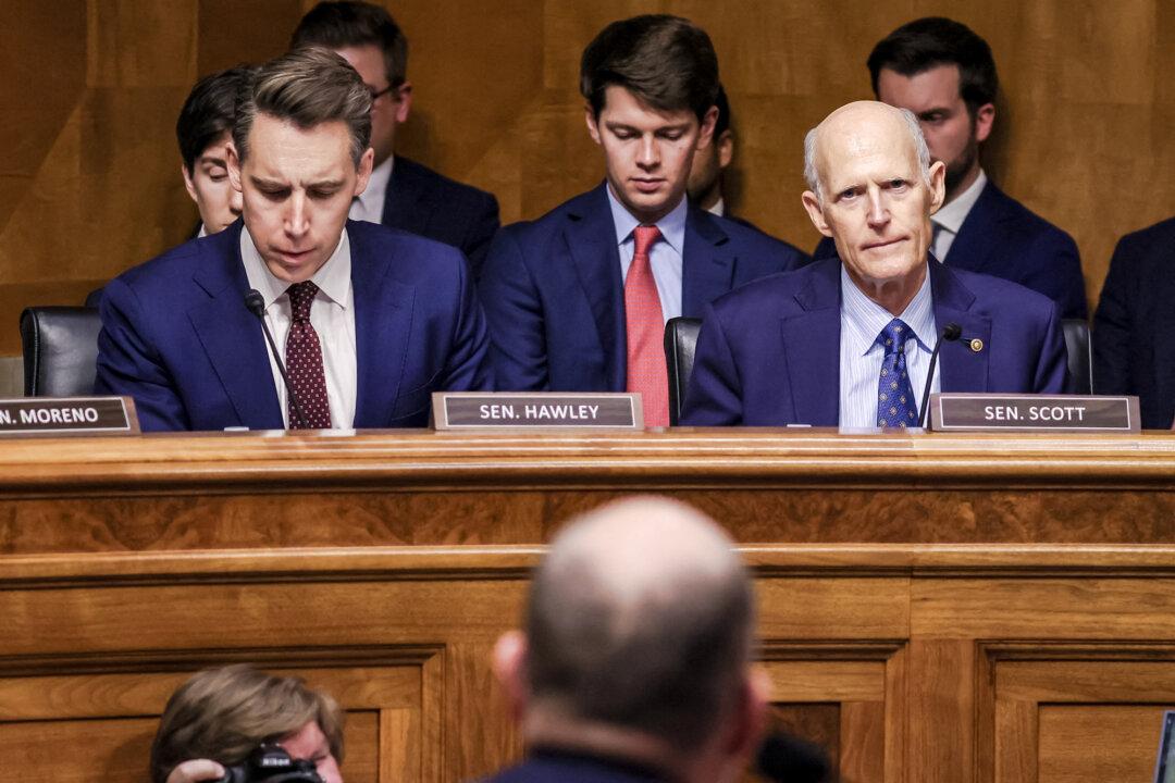 Sens. Josh Hawley (R–Mo.) (L) and Rick Scott (R–Fla.) (R) question former Office of Management and Budget Director Russ Vought during a Senate hearing on his nomination to be OMB director, in Washington on Jan. 15, 2025. (Jemal Countess/AFP via Getty Images)