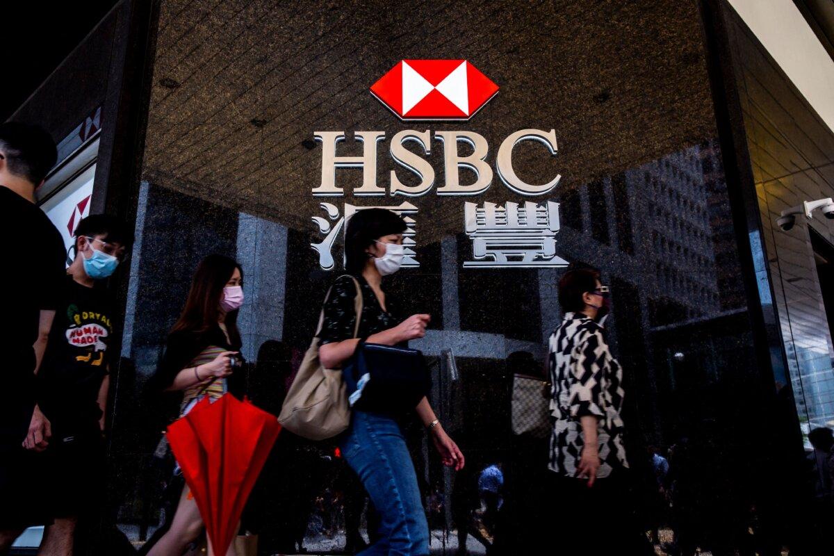 Pedestrians walk past the logo for HSBC outside a local branch bank in Hong Kong on Aug. 2, 2021. (Isaac Lawrence/AFP via Getty Images)