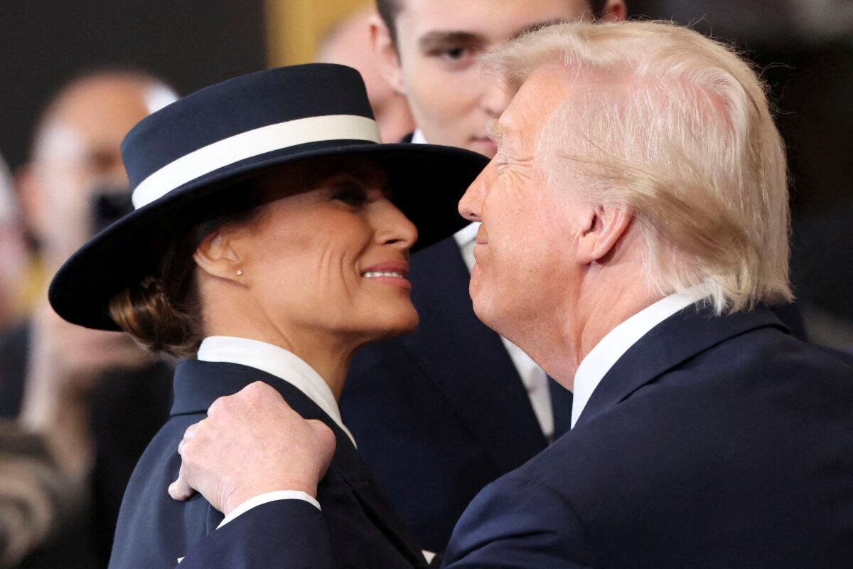 President Donald Trump and First Lady Melania Trump embrace after he was sworn in inside the Rotunda of the US Capitol in Washington, DC, on Jan. 20, 2025. (KEVIN LAMARQUE/POOL/AFP via Getty Images)