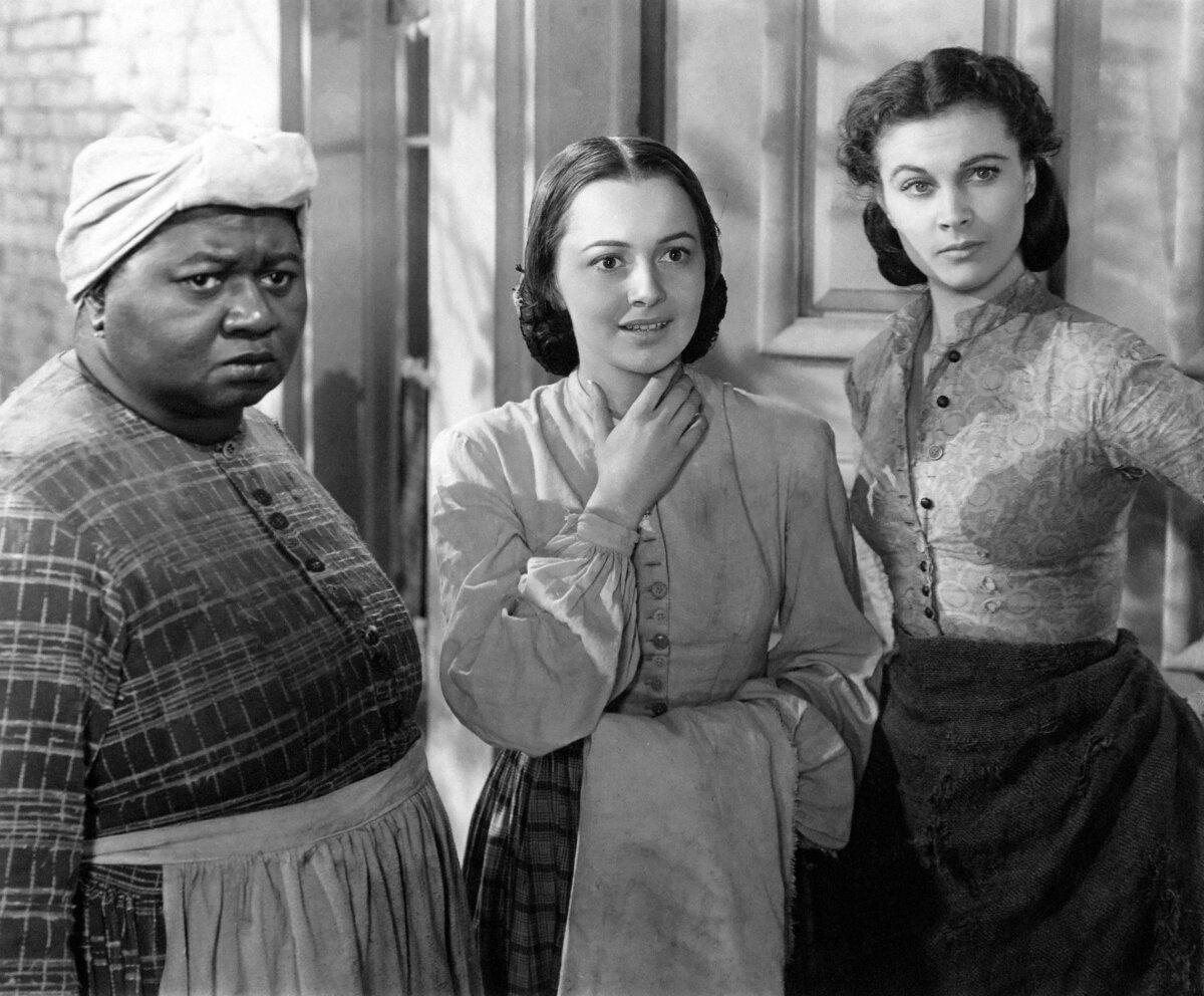 The women in Rhett Butler's life: (L-R) Mammie (Hattie McDaniel), Melanie Wilkes (Olivia de Havilland), and Scarlett O'Hara (Vivien O'Hara, in "Gone with the Wind." (MGM/MovieStillsDB)