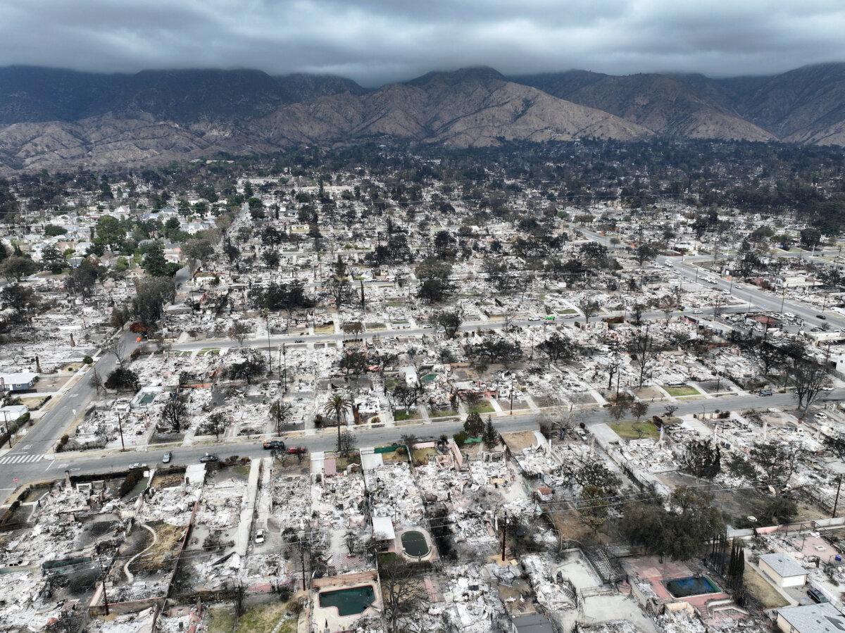 An aerial view of homes burned in the Eaton Fire, with storm clouds hanging over the San Gabriel Mountains, in Altadena, Calif., on Jan. 25, 2025. (Mario Tama/Getty Images)