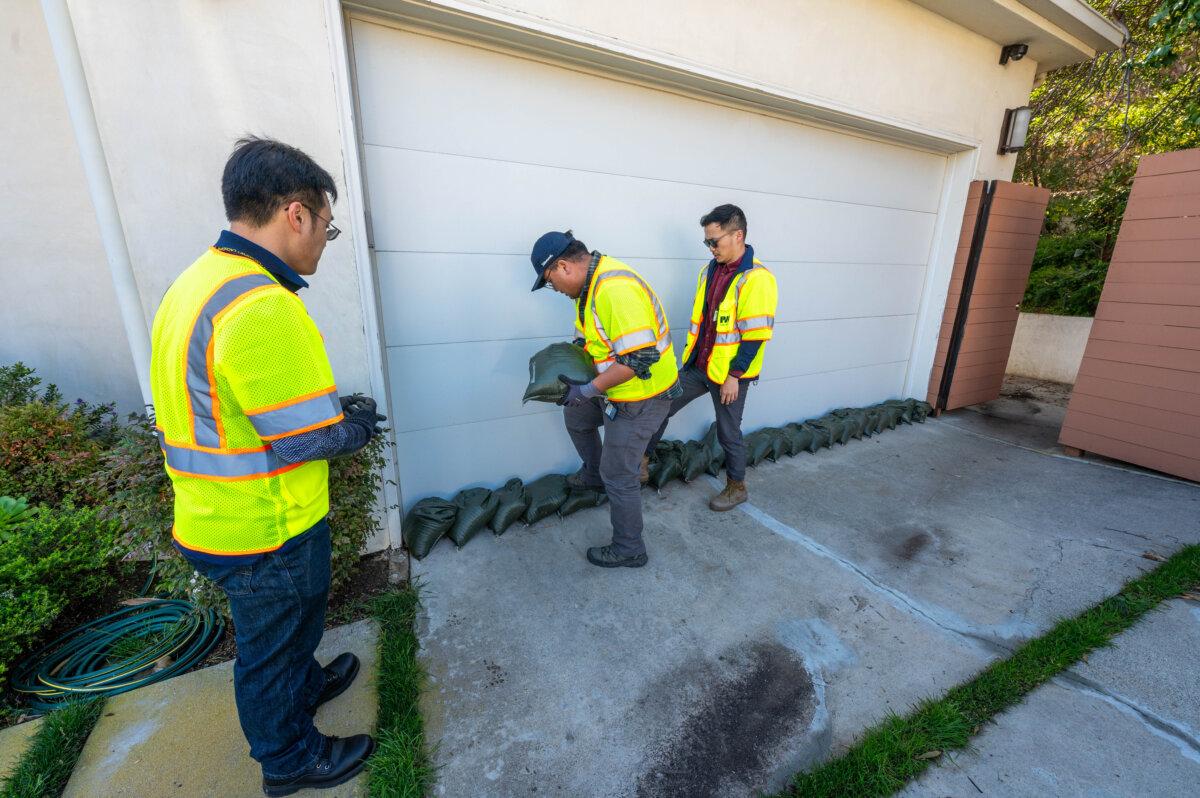 Volunteers place sandbags to protect homes in the Pacific Palisades area of Los Angeles ahead of a rainstorm. (Los Angeles County Public Works)
