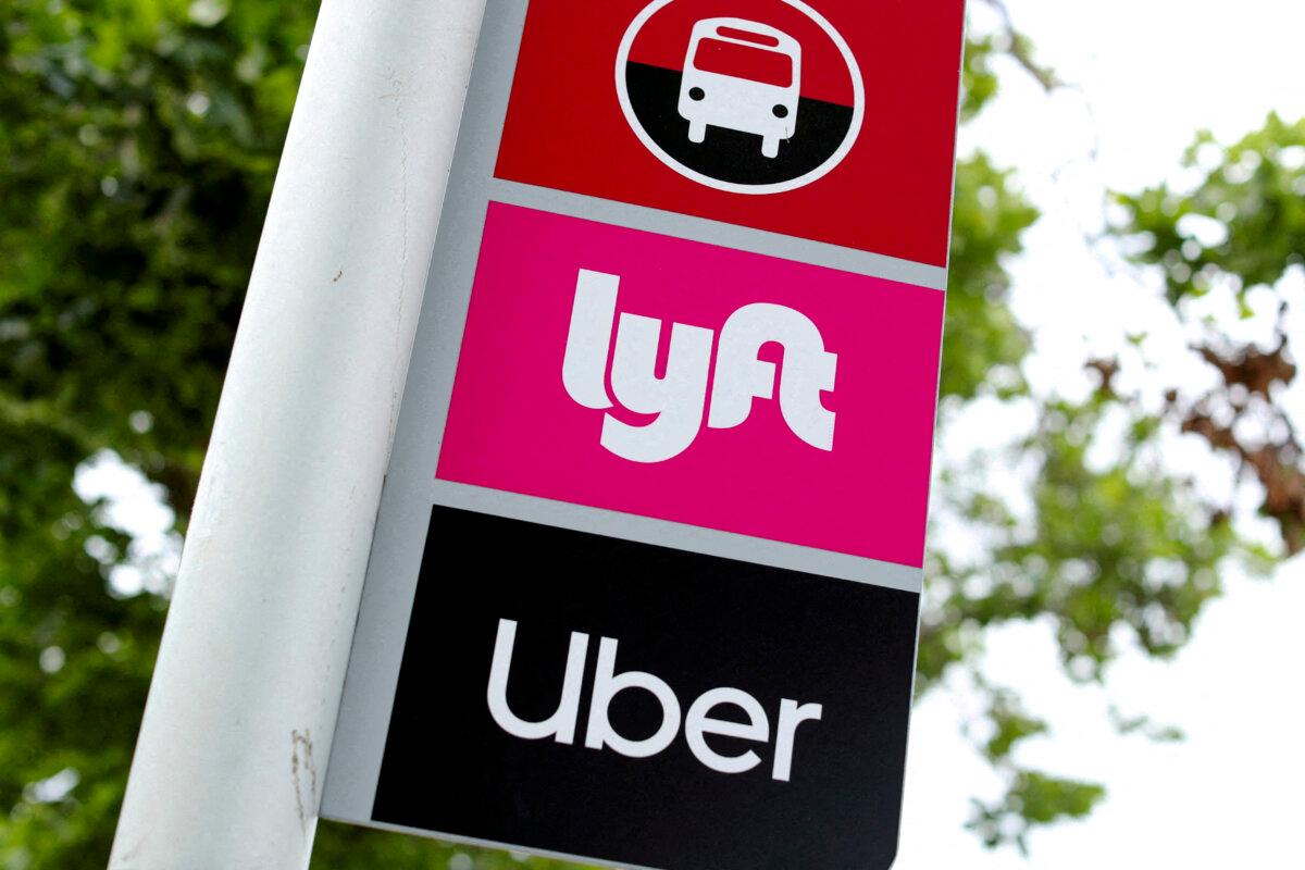 A sign marks a rendezvous location for Lyft and Uber users at San Diego State University in San Diego on May 13, 2020. (Mike Blake/Reuters, File Photo)
