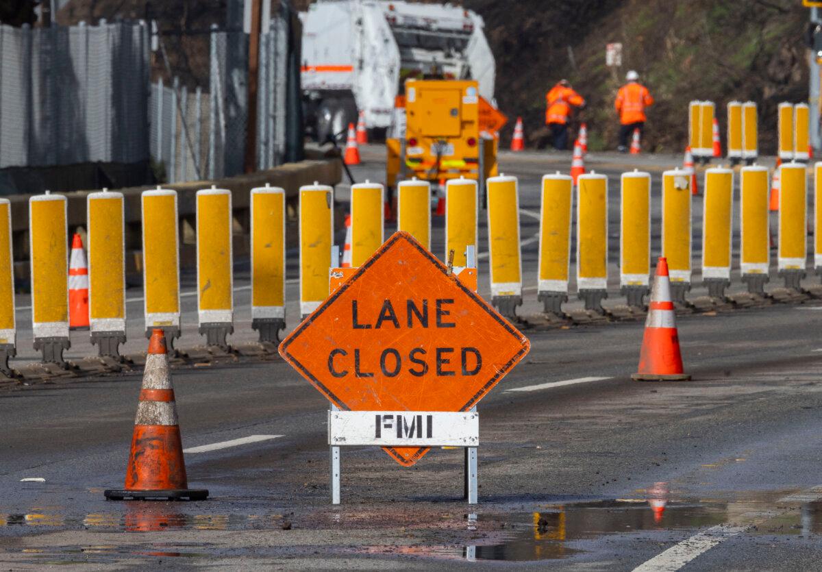 First responders and clean-up crews work to clear mud and debris flows left over from the Palisades Fire caused by heavy rains along Pacific Coast Highway near Los Angeles on Feb. 14, 2024. (John Fredricks/The Epoch Times)