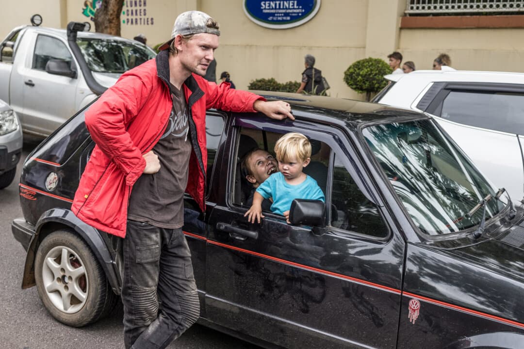 A family gathers around their car as white South Africans supporting President Donald Trump and South African-born Elon Musk leave the U.S. Embassy in Pretoria, South Africa, at the end of a demonstration on Feb. 15, 2025. Trump and Pretoria are locked in a diplomatic row over a land expropriation act that Washington says will lead to the takeover of white-owned farms. Trump said on Feb. 7 that the law signed in January would “enable the government of South Africa to seize ethnic minority Afrikaners' agricultural property without compensation.” (Marco Longari/AFP via Getty Images)
