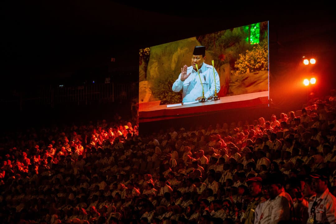 Indonesia's President Prabowo Subianto, who also serves as the chairman of the Great Indonesia Movement Party (Gerindra), is seen on a large screen as he speaks during the party's 17th anniversary in Bogor, West Java, on Feb. 15, 2025. (Aditya Aji/AFP via Getty Images)
