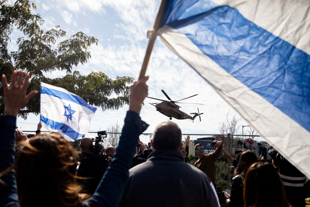 Supporters cheer and hold Israeli flags as an Israeli helicopter carrying freed hostages Sagui Dekel Chen and Sasha Troufanov lands at a hospital after they were released from Hamas captivity in Ramat gan, Israel, on Feb. 15, 2025. Hamas informed the Israeli government on Friday that Sagui Dekel Chen, Alexander Sasha Troufanov, and Iair Horn would be released today, as part of a cease-fire deal that seemed in jeopardy earlier in the week. (Amir Levy/Getty Images)