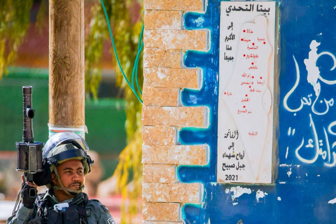 An Israeli soldier stands guard near a wall in Beita, south of Nablus, on Feb. 14, 2025. (Wahaj Bani Moufleh/Middle East Images/AFP via Getty Images)