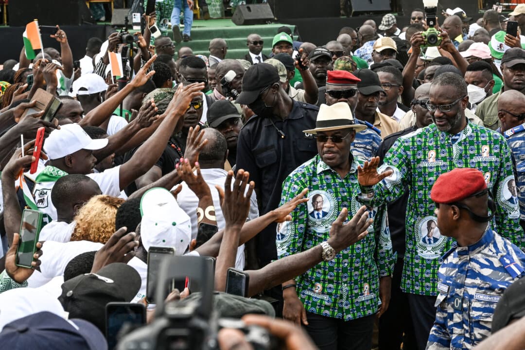 Tidjane Thiam (R), the president of the Democratic Party of Ivory Coast (PDCI), greets his supporters upon his arrival for a mobilisation meeting for the presidential election of October 2025, in Yopougon, a popular commune in Abidjan, Ivory Coast, on Feb. 15, 2025. (Sia Kambou/AFP via Getty Images)