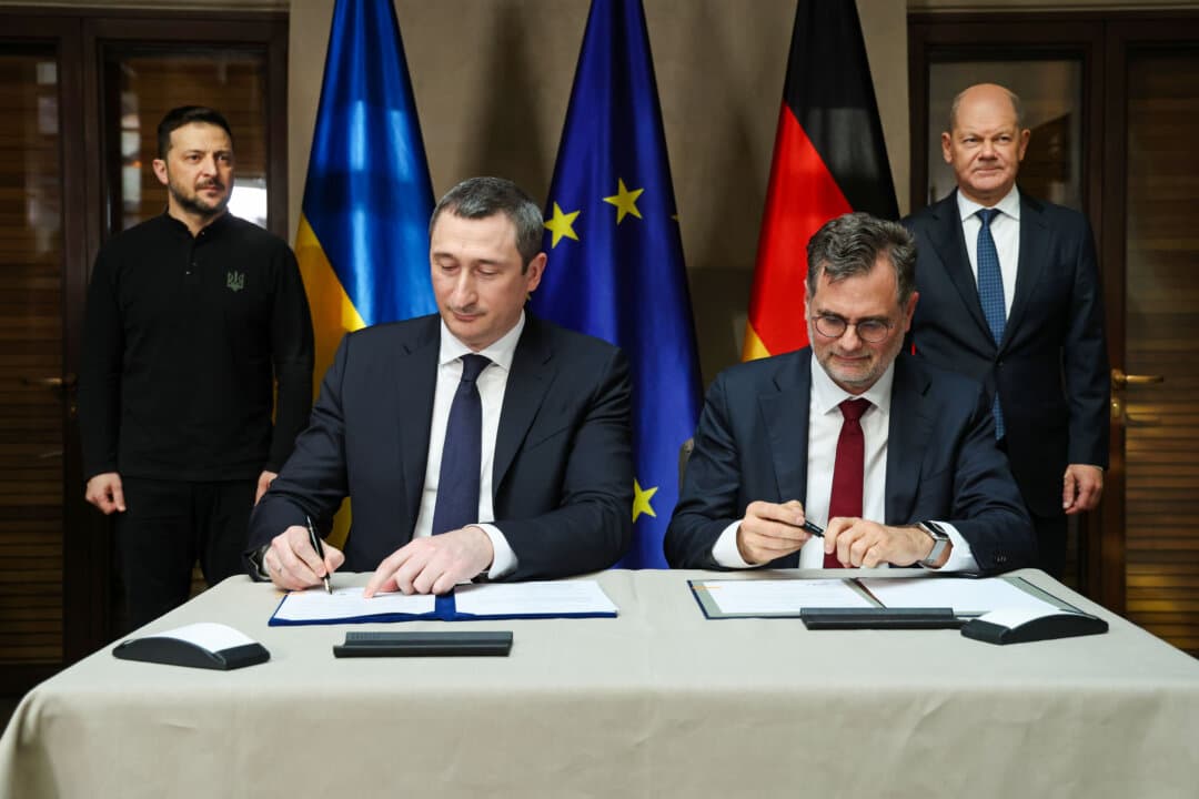 Ukraine Deputy Prime Minister Oleksiy Chernyshov (C-L) and German Chancellery Minister Wolfgang Schmidt (C-R) sign a mutual letter of intent on the creation of a “Unity Hub” as Ukrainian President Volodymyr Zelensky and German Chancellor Olaf Scholz look on at the 61st Munich Security Conference in Munich, Germany, on Feb. 15, 2025. International defense and security leaders from around the world are gathering for the Feb. 14–16 conference. (Sean Gallup/Getty Images)