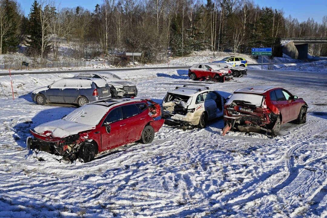 Damaged cars involved in a mass crash on the motorway between Enkoping and Balsta in Sweden stand on a field on Feb. 16, 2025. An intense snowstorm sparked two massive road accidents involving dozens of vehicles and leaving more than 100 people needing hospital treatment, officials said. (Anders Wiklund/TT News Agency/AFP via Getty Images)