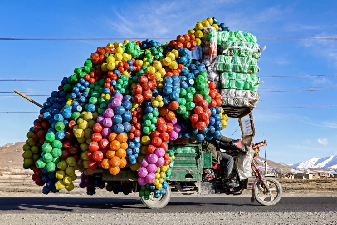 An Afghan vendor carries plastic cans on a three-wheeler rickshaw along a street on the outskirts of Maidan Wardak province on Feb. 16, 2025. (Mohammad Faisal Naweed/AFP via Getty Images)