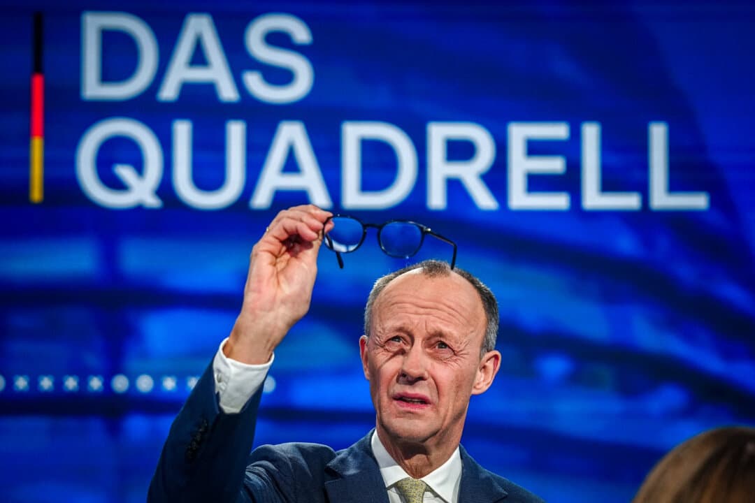 Friedrich Merz, main candidate and chairman of the Christian Democratic Union (CDU), checks his glasses prior to a TV debate in Berlin on Feb. 16, 2025, ahead of the parliamentary elections. (Kay Nietfeld/POOL/AFP via Getty Images)