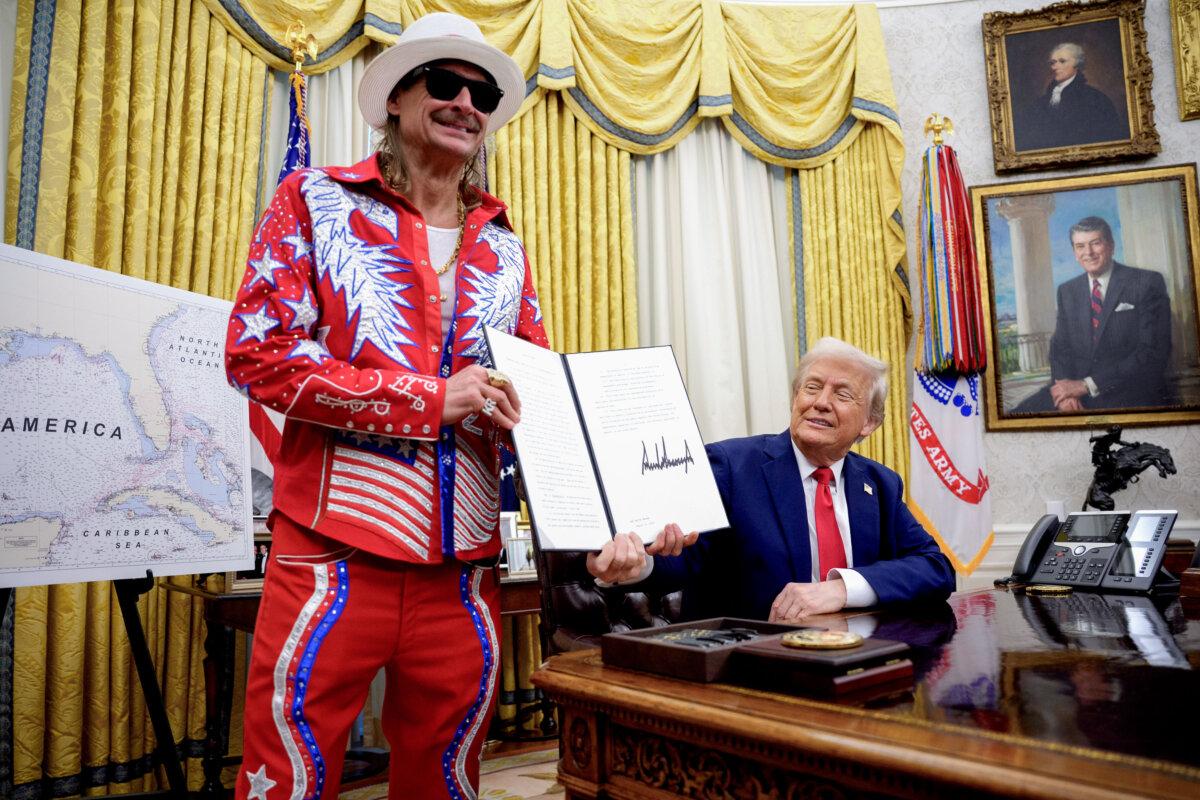 President Donald Trump, accompanied by entertainer Kid Rock, signs an executive order in the Oval Office of the White House on March 31, 2025. (Andrew Harnik/Getty Images)